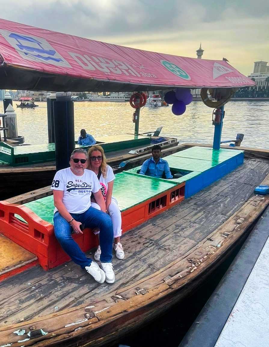 A couple enjoying a serene boat ride on the water, surrounded by calmness and tranquility-Dubai