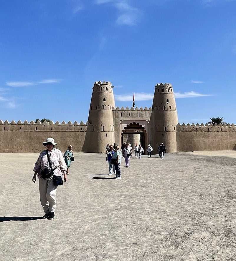 A man kindly offers food to a woman and another man oase Al Ain--