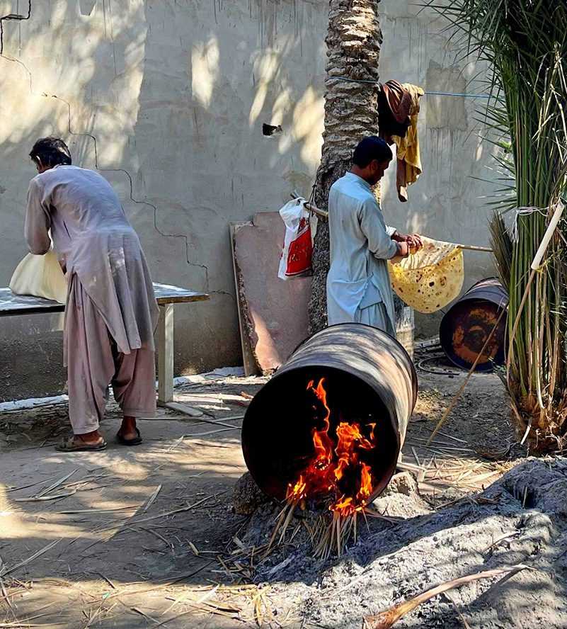 A man kindly offers food to a woman and another man oase Al Ain-