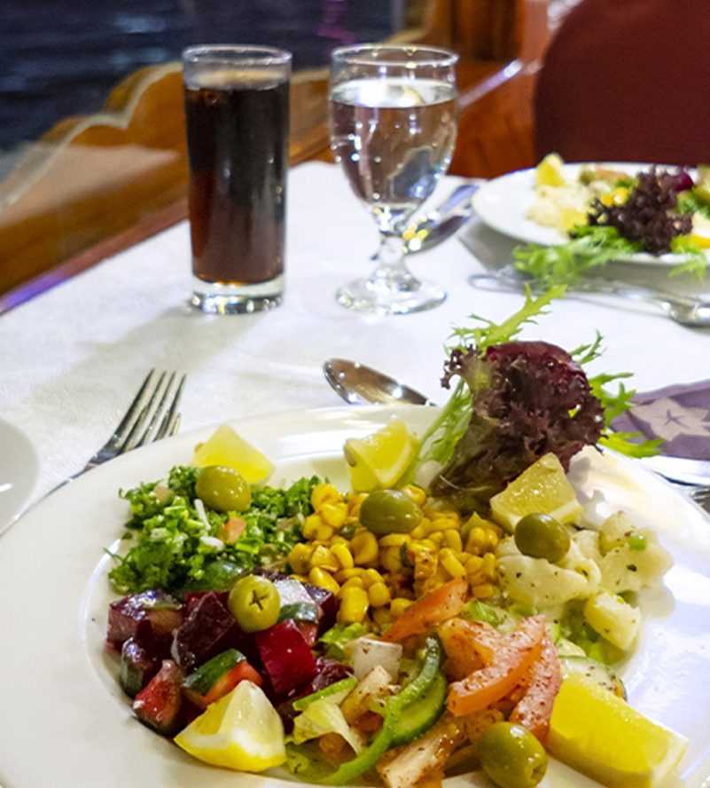 A plate filled with delicious food, showcasing a variety of flavors and textures-Cruise Dubai