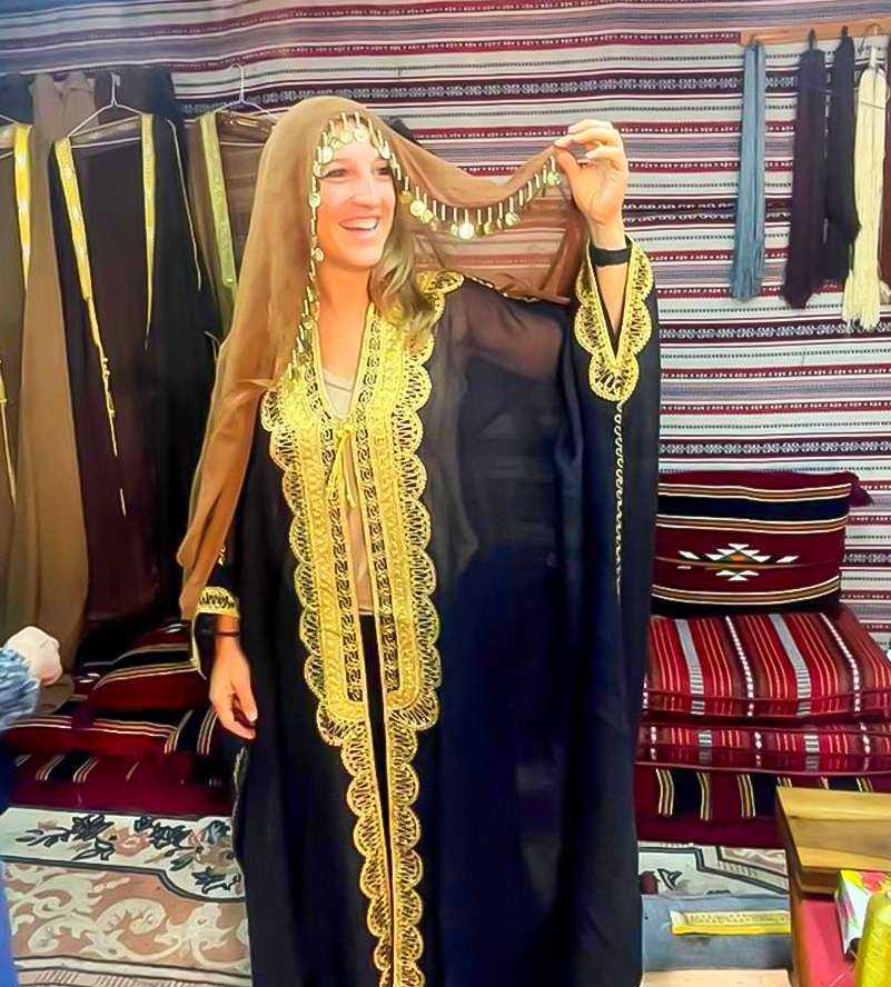 A woman in an elegant oriental dress striking a pose for a photograph