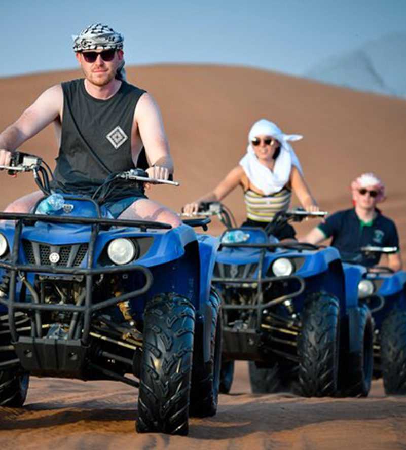 A woman silhouetted against the sun, extending her hand Dubai desert copy