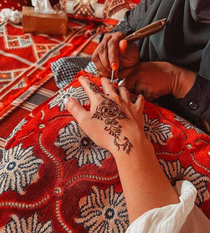 A woman's hand adorned with a beautiful henna tattoo, showcasing intricate patterns and cultural artistry Dubai