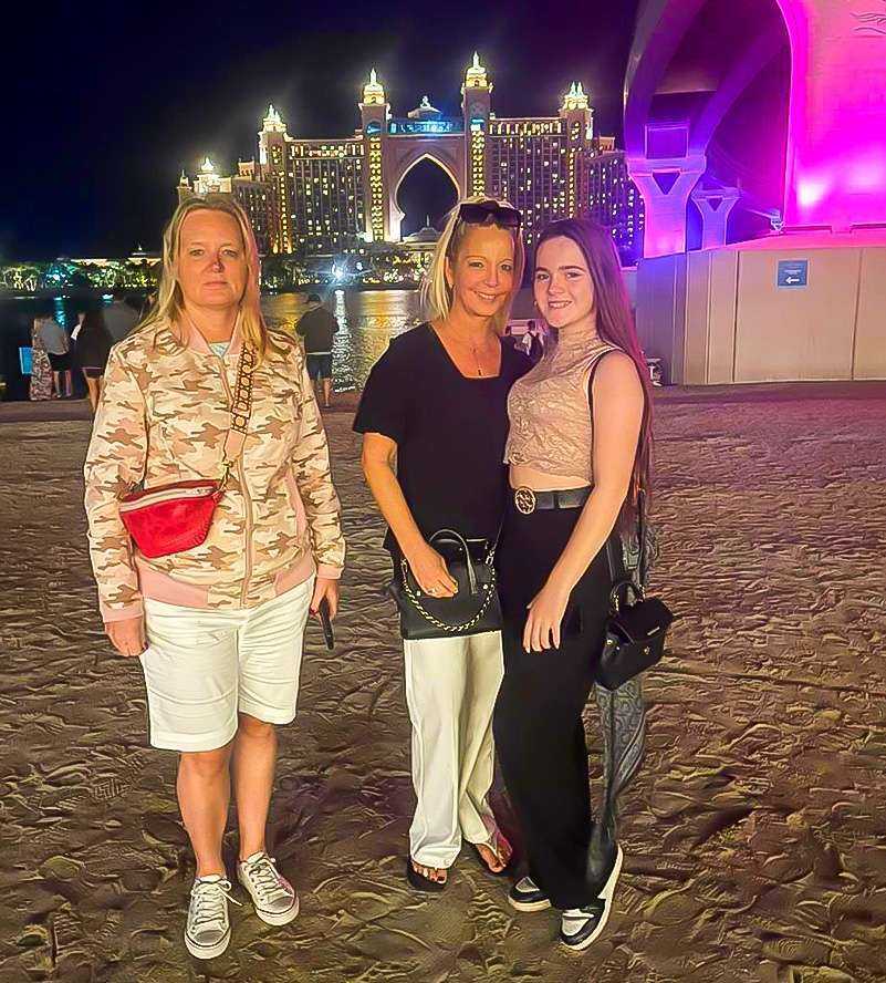 Atlantis captivating image of three women standing on a moonlit beach