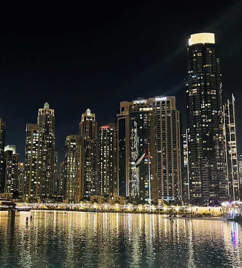 Boats docked near tall buildings in the water Dubai--