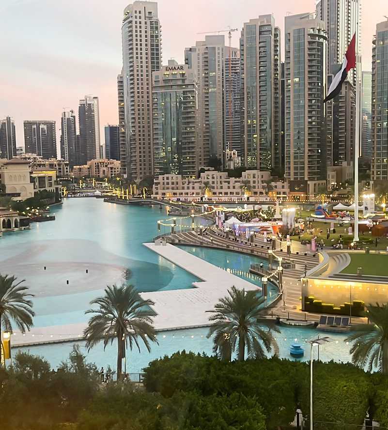 Boats docked near tall buildings in the water Dubai-