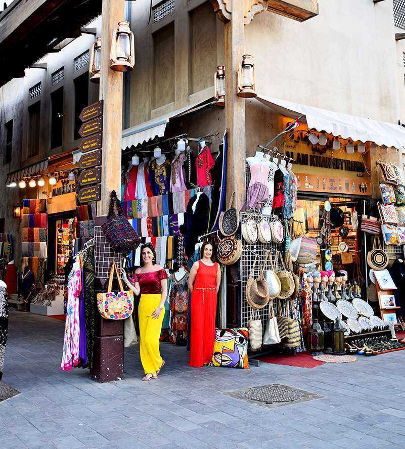 Bur Dubai Souk Market A woman wearing a vibrant red dress, exuding elegance and confidence