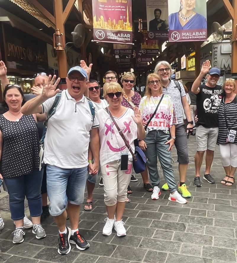 Dubai Gold Souk Group of people posing for picture in front of buildi()