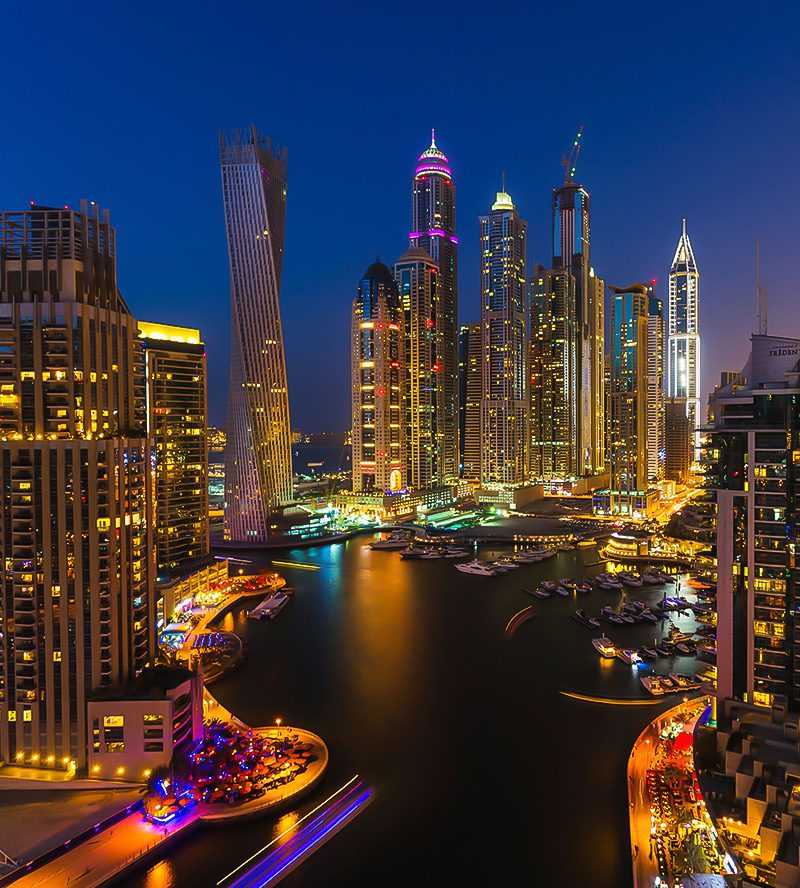 Four women enjoying a serene night on a dock