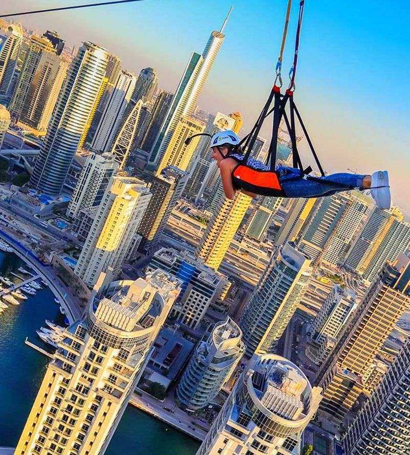 Girl Fly over Dubai Marina on the world's longest inner-city zipline.