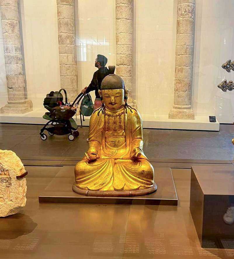 Golden Buddha statue on display in museum