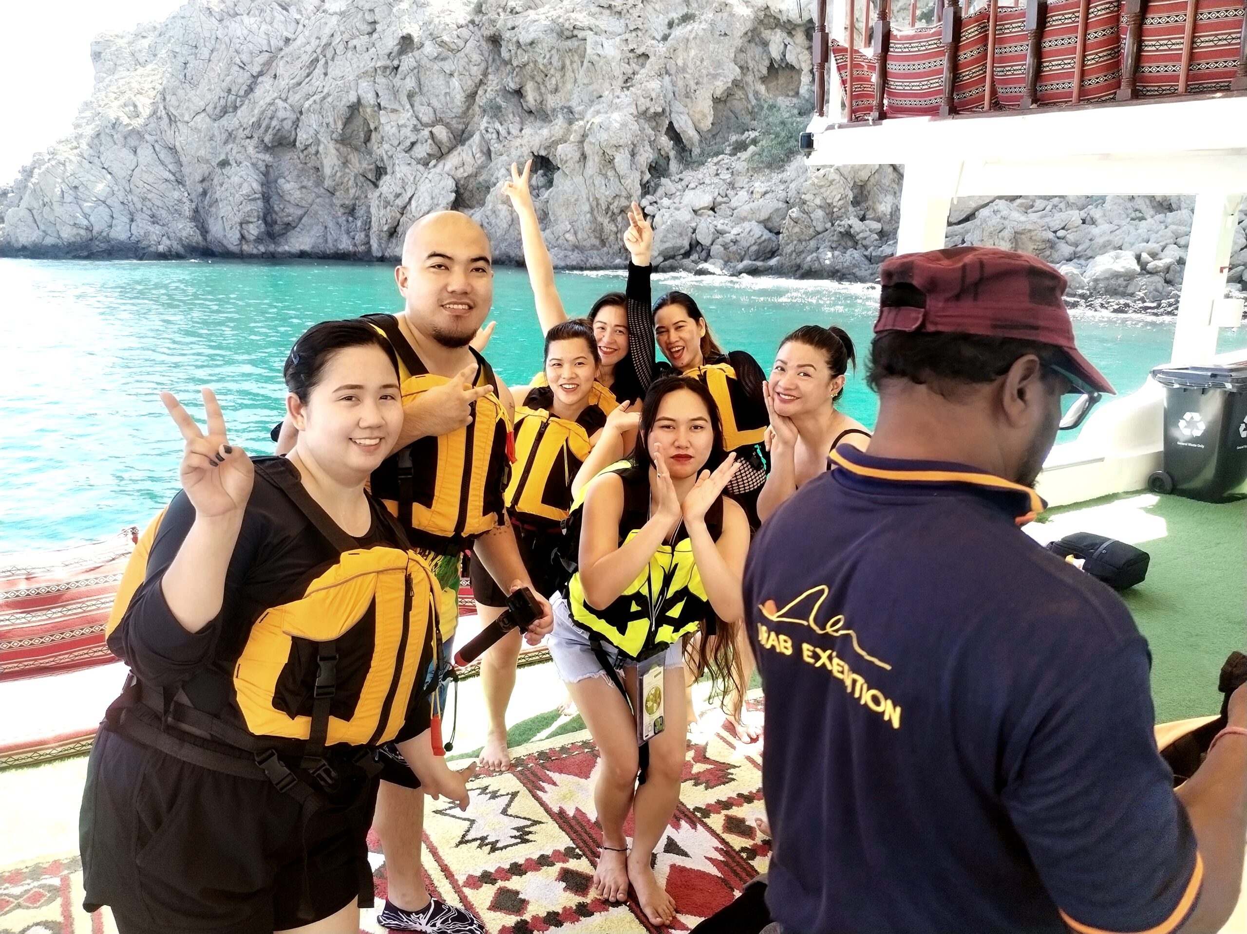They are enjoying their time aboard a traditionally decorated boat known as a dhow