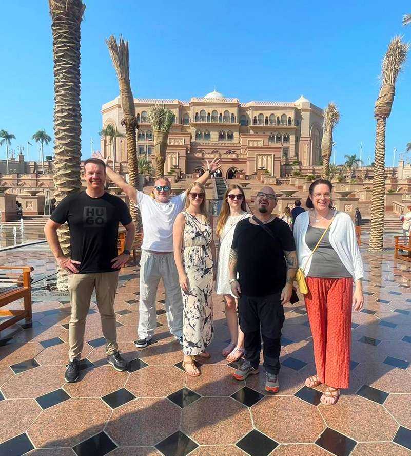 People posing for photo in front of Emirates Palace
