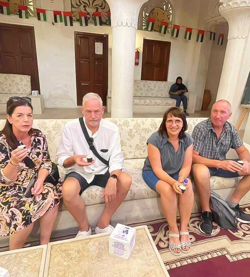 People sitting on a couch in a room dubai
