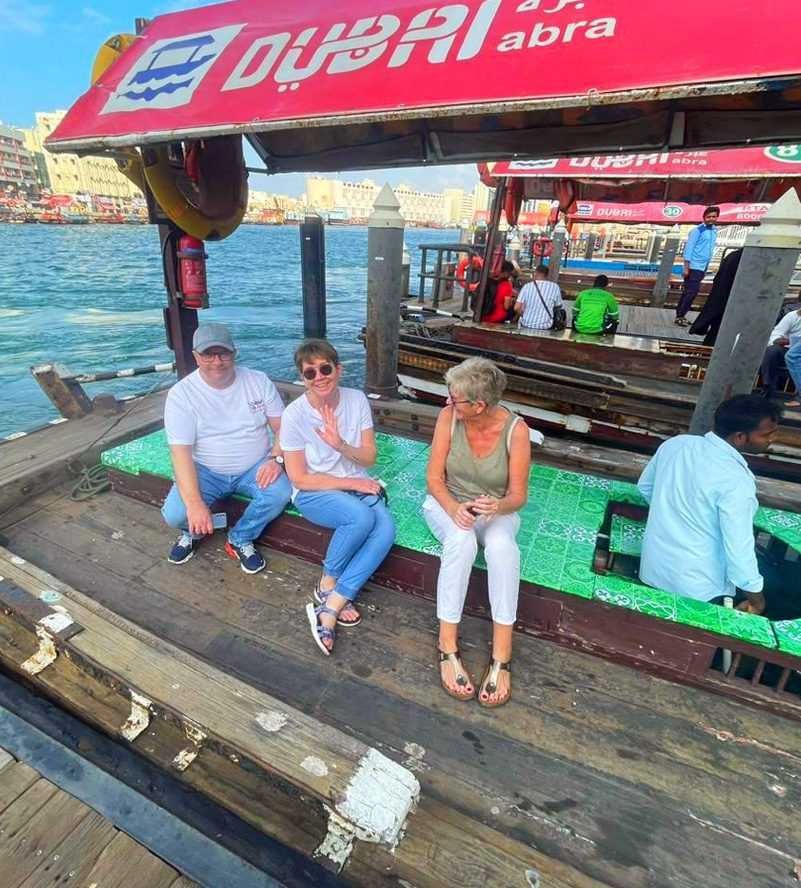 Three people enjoying a boat ride together-Dubai Sightseeing Tour