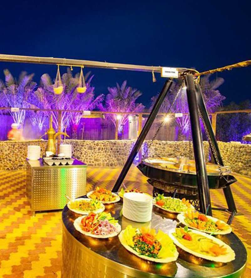 Dubai Two people riding ATVs in the desert at sunset Ras Al Khaimah copy