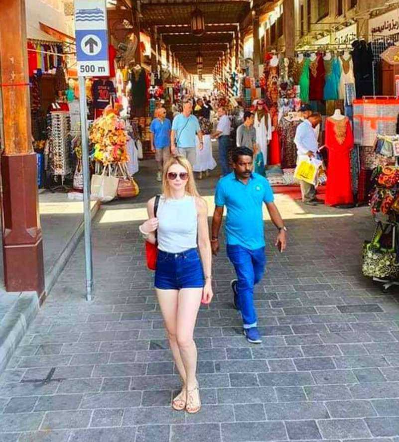 Woman navigating bustling market stalls