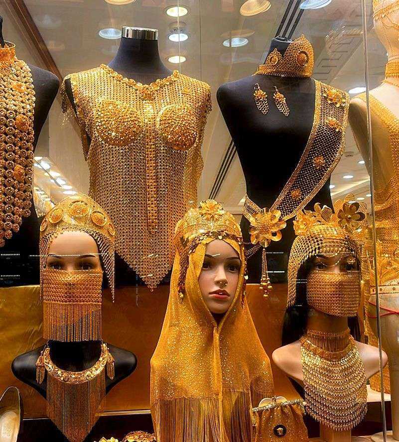 a display of gold jewelry Duabi at night