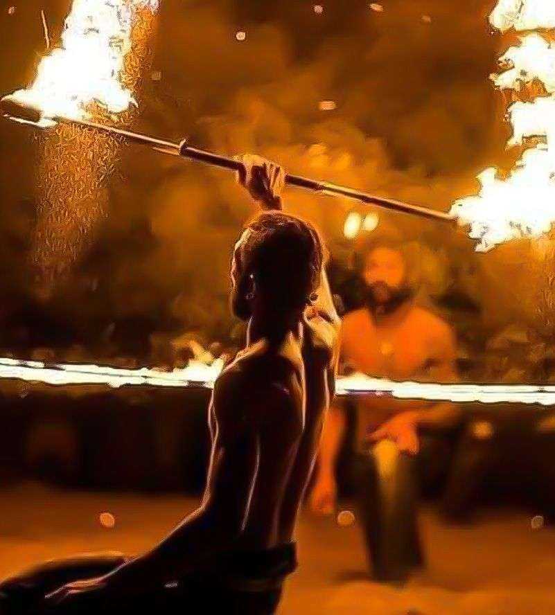 a man holding a fire stick in the air-Dubai desert