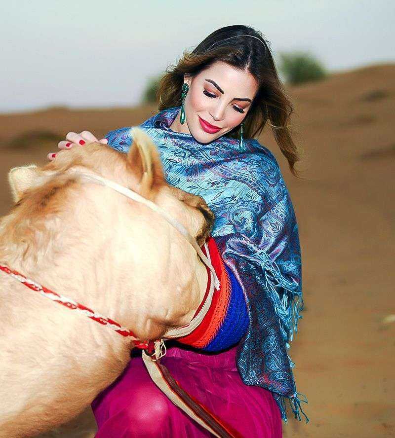 a woman with a camel