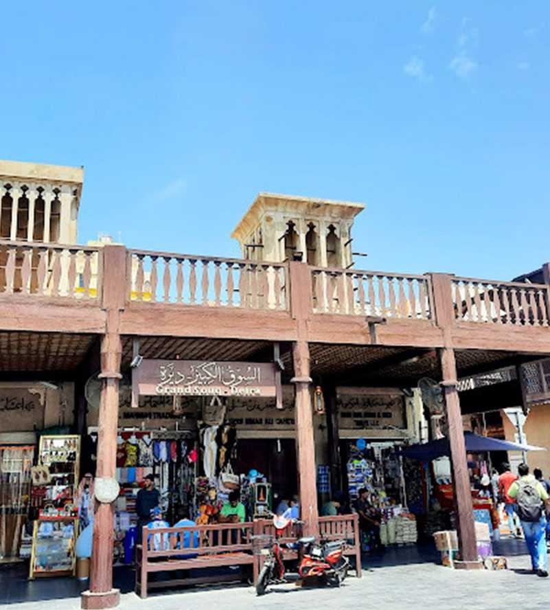 bustling city shop with pedestrians walking around-Dubai Sightseeing Tour