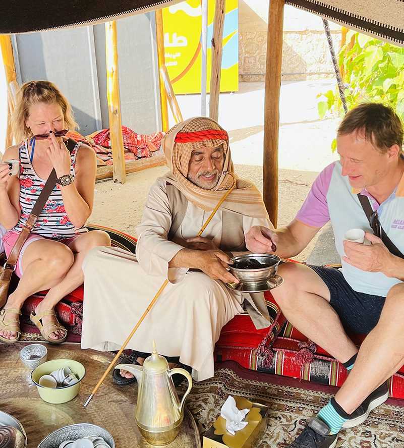 diverse group of individuals enjoying a meal together at a table dubai