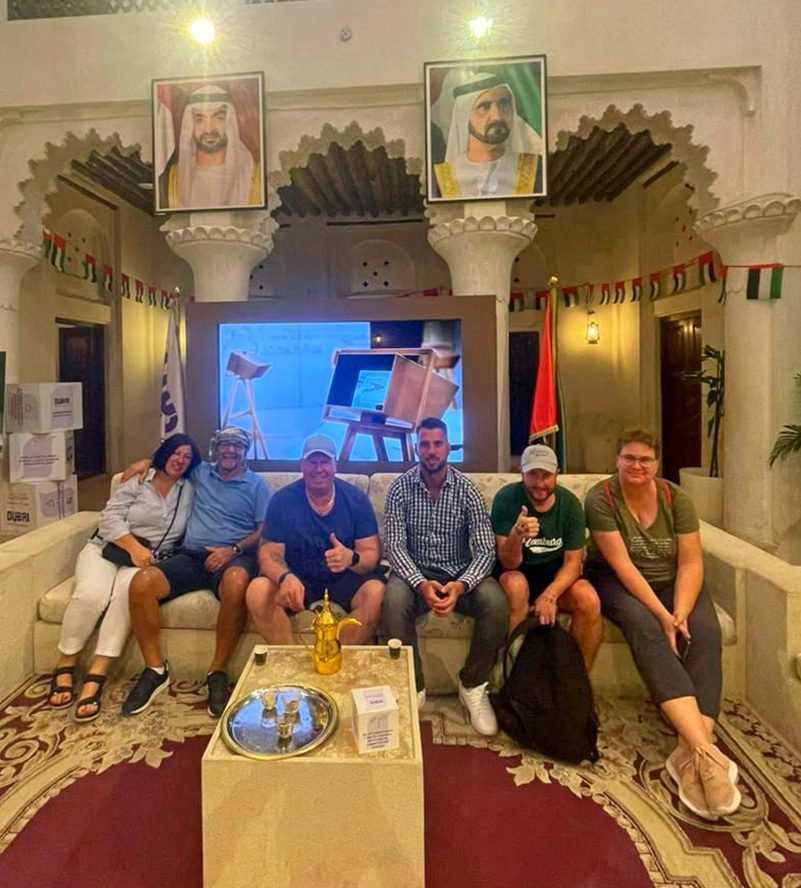 group of individuals sitting on a hotel lobby couch, engaged in conversation and relaxation-Dubai Sightseeing Tour