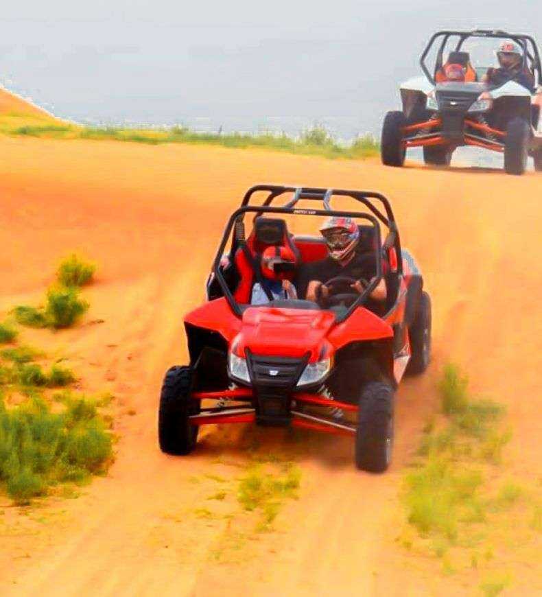 group of people driving off desert Dubai Safari