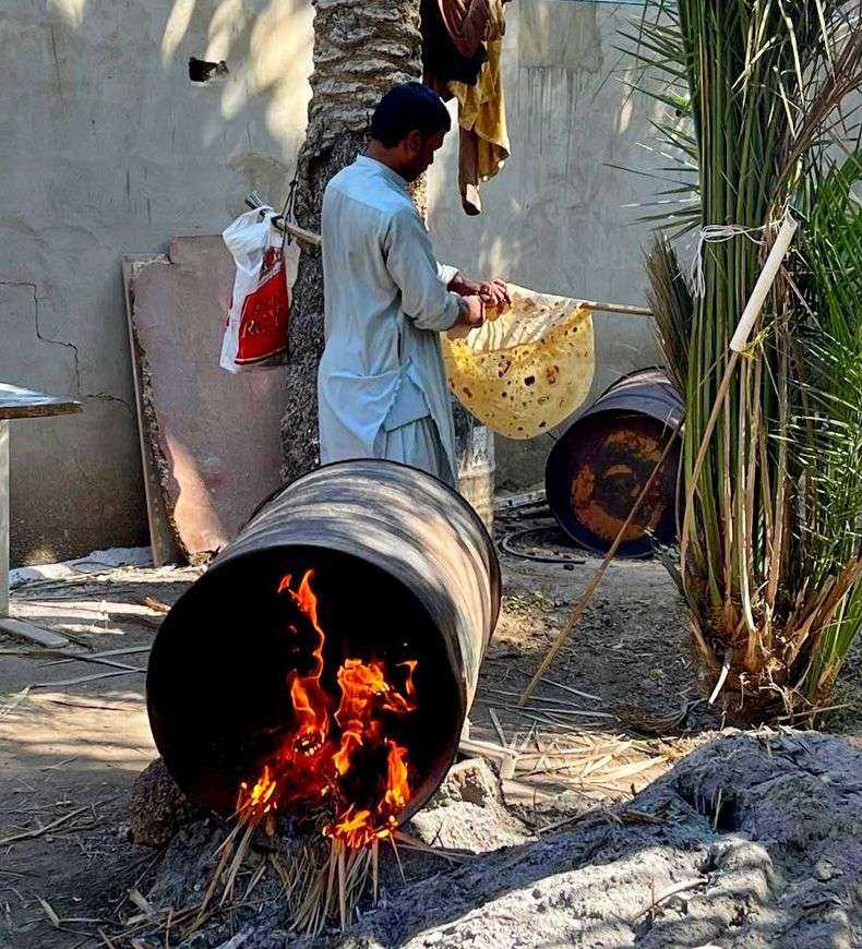 person cooking food in a barrel-Al Ain Oasis Abu Dhabi