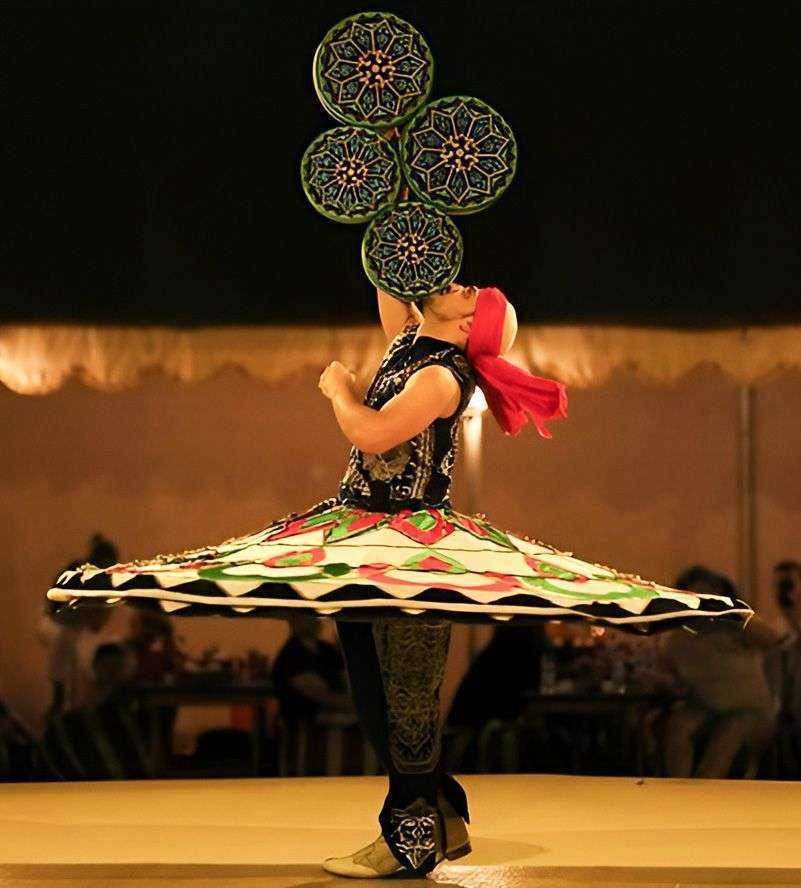 person in a skirt with a large circle of green and yellow circles on her head
