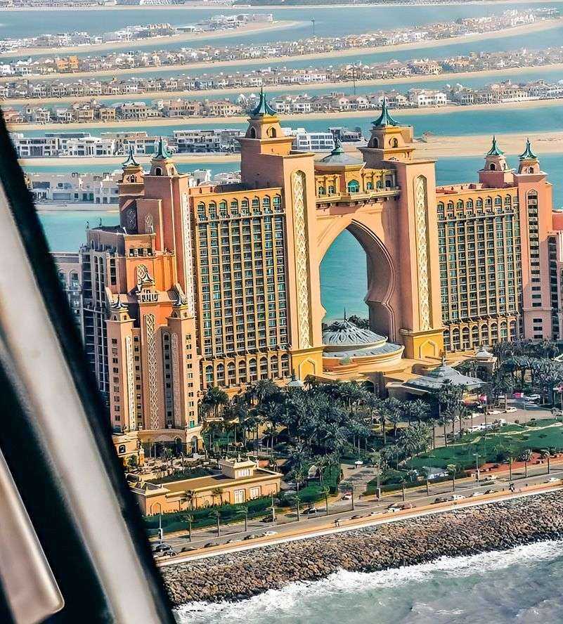 large building with a large arch with Atlantis, The Palm in the background
