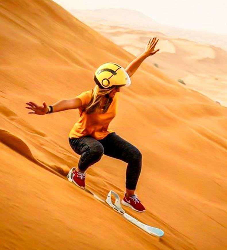 person riding a snowboard in the desert Dubai Safari