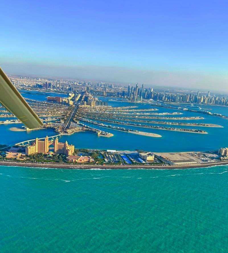 helicopter flying over Dubai city