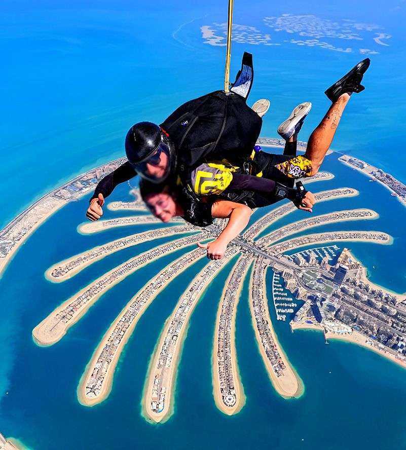 person skydiving with a person in the sky