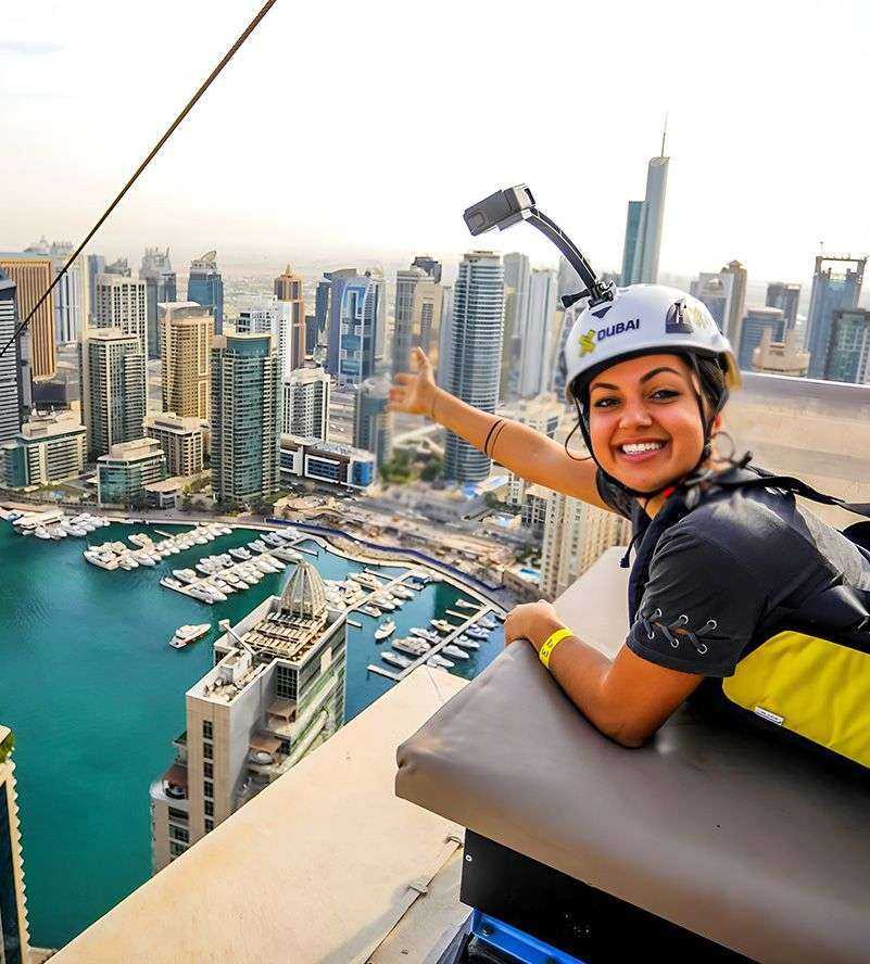 person wearing a helmet and holding a camera up to her face