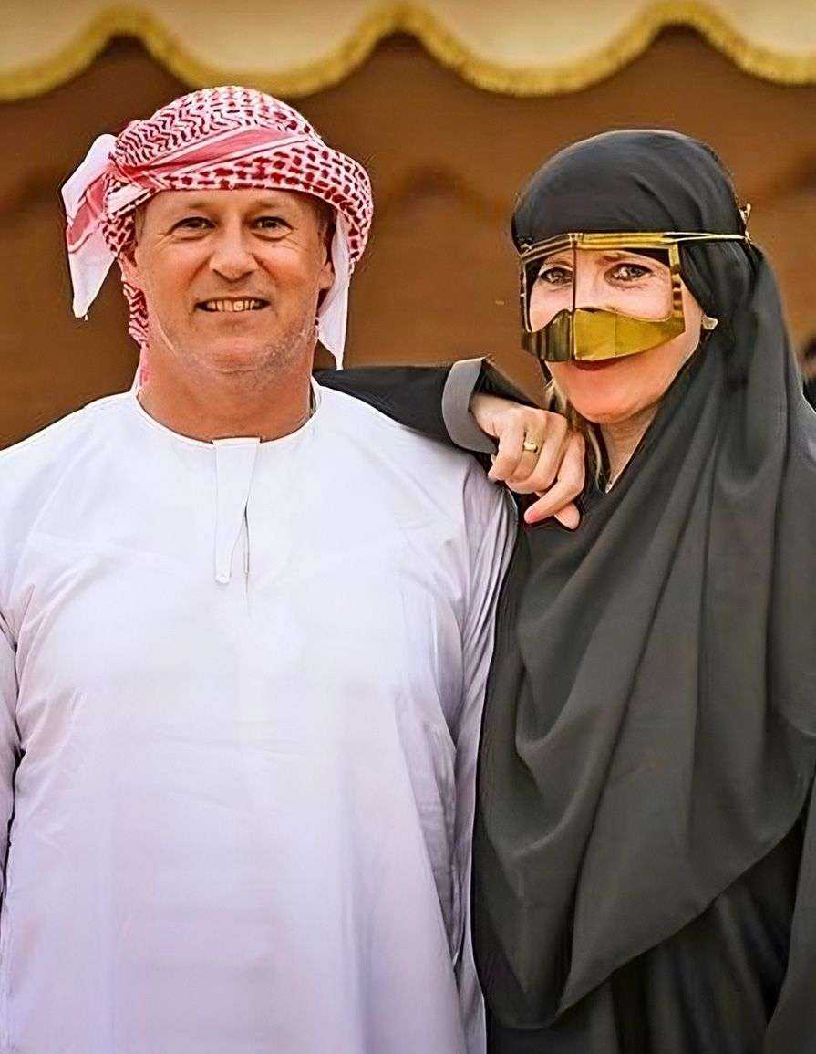person wearing head coverings and gold mask-Dubai desert