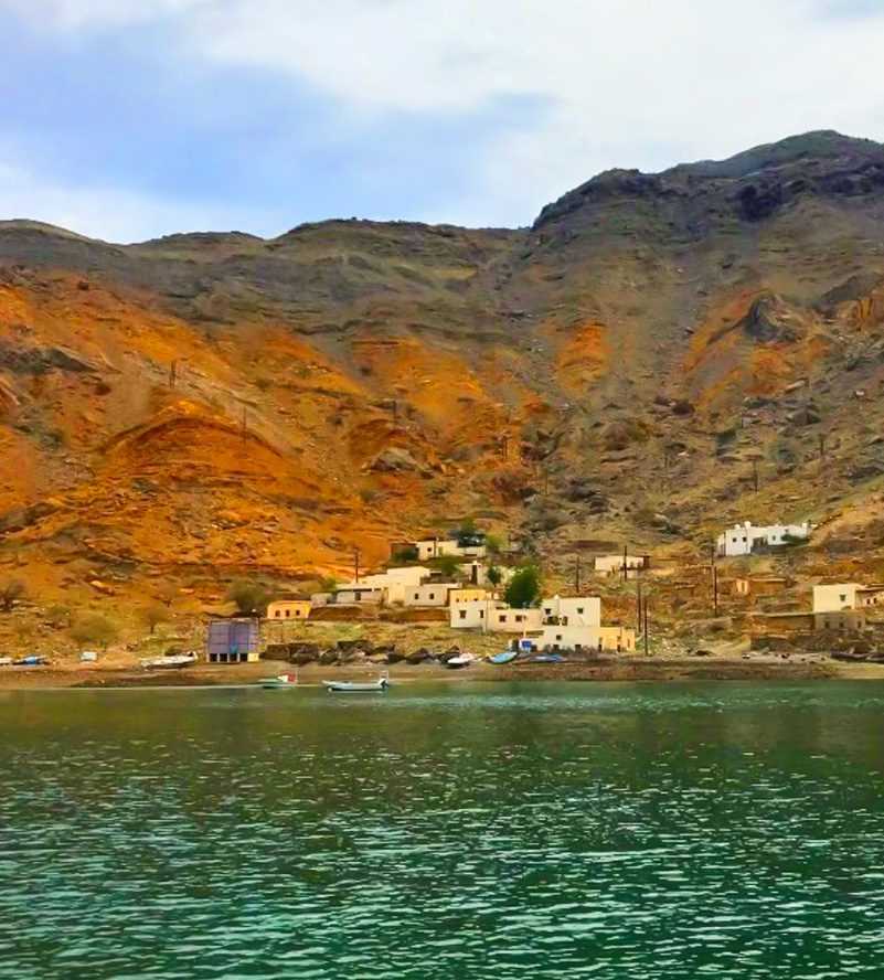 picturesque coastal town nestled amidst majestic mountains-Dhow Cruise Tour In Khasab Musandam
