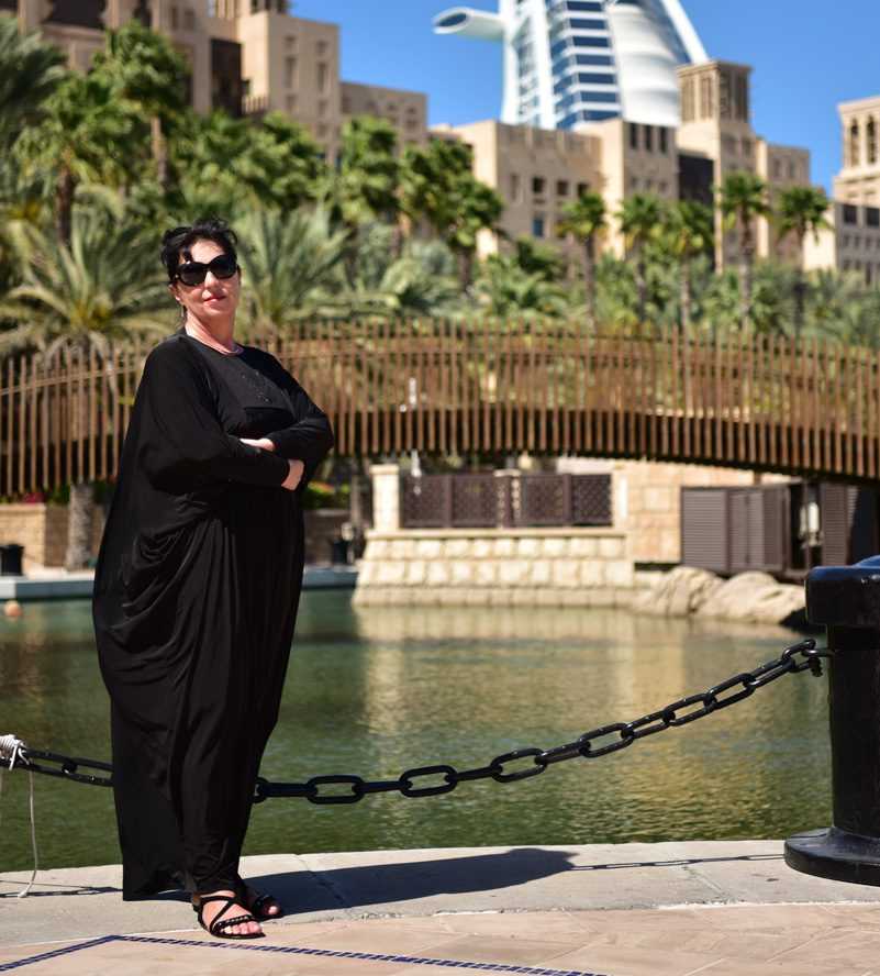 woman in black standing in front of the iconic Burj Al Arab hotel-Dubai Sightseeing Tour