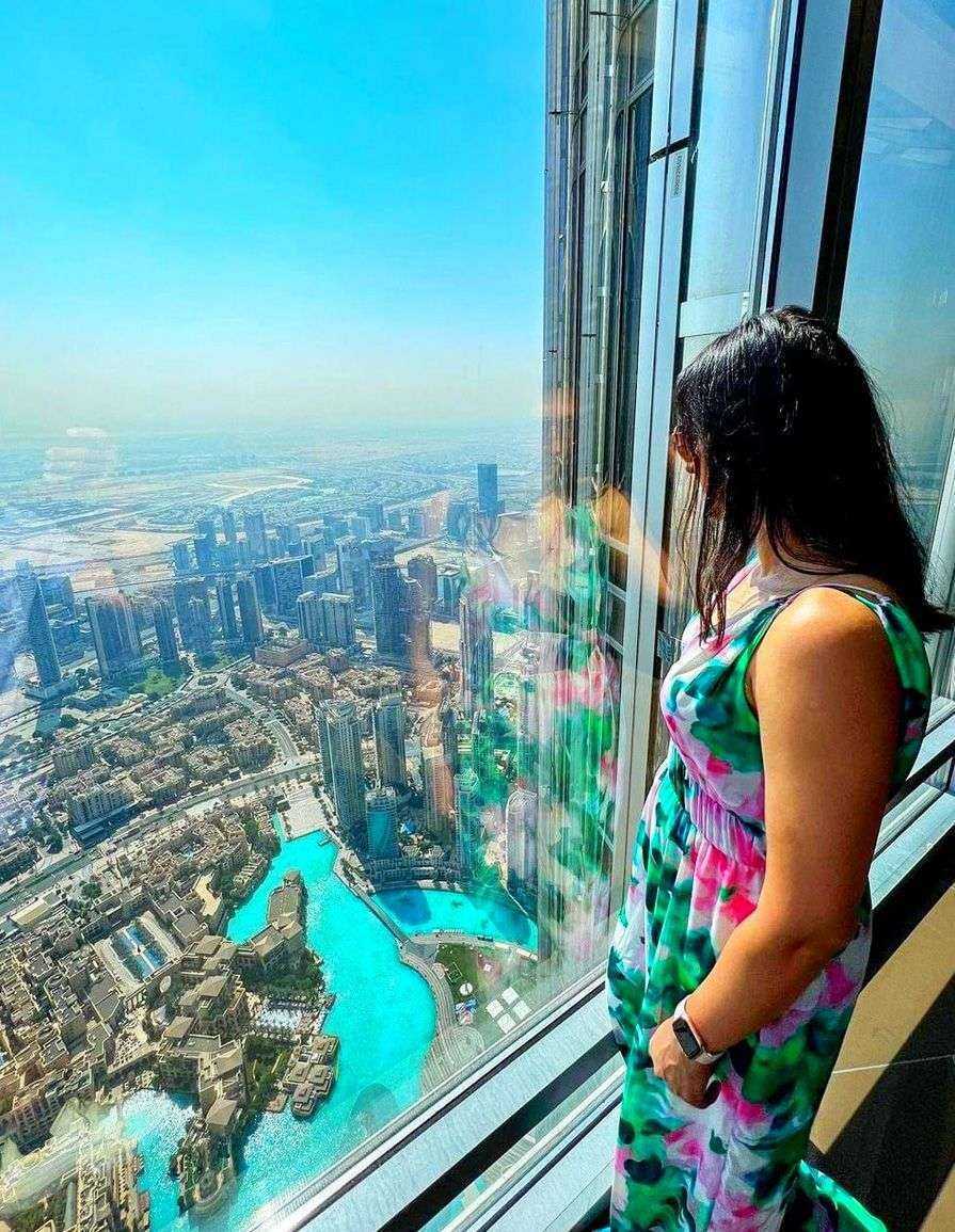 woman looking out a window at-Burj Khalifa