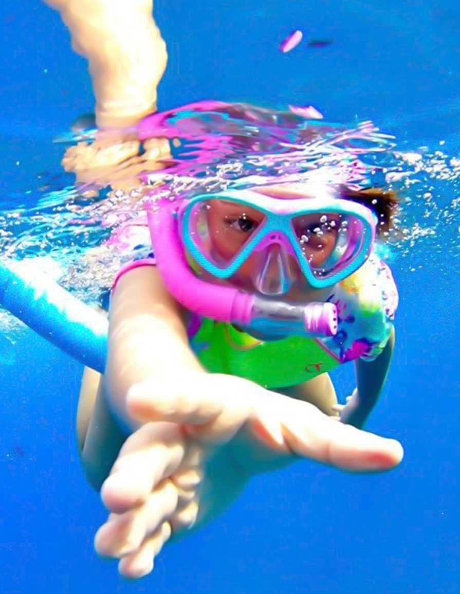 young girl with a snorkel and a pink paddle in her hands-Dhow Cruise Tour In Khasab Musandam